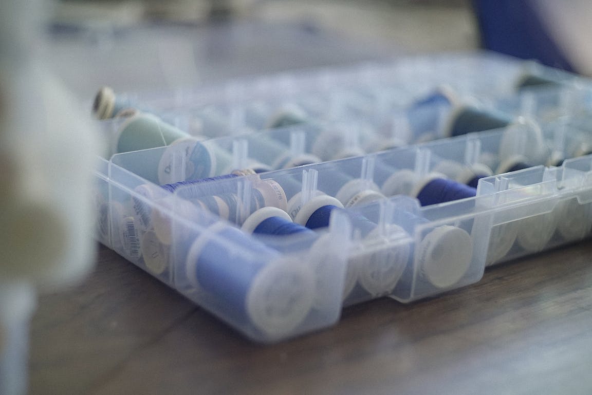 A container of various purple threads.